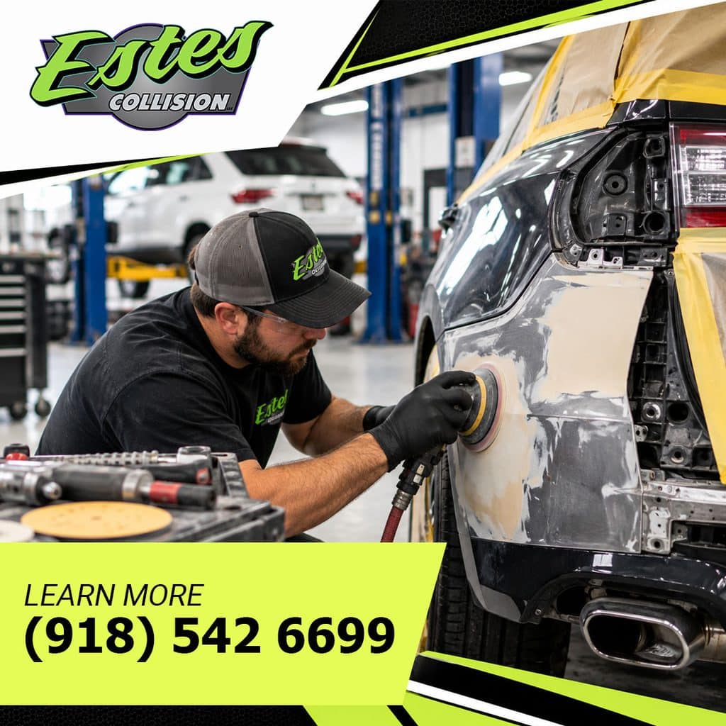 An auto body technician using a pneumatic dual-action sander to smooth body filler on a vehicle rear quarter panel in a repair bay.