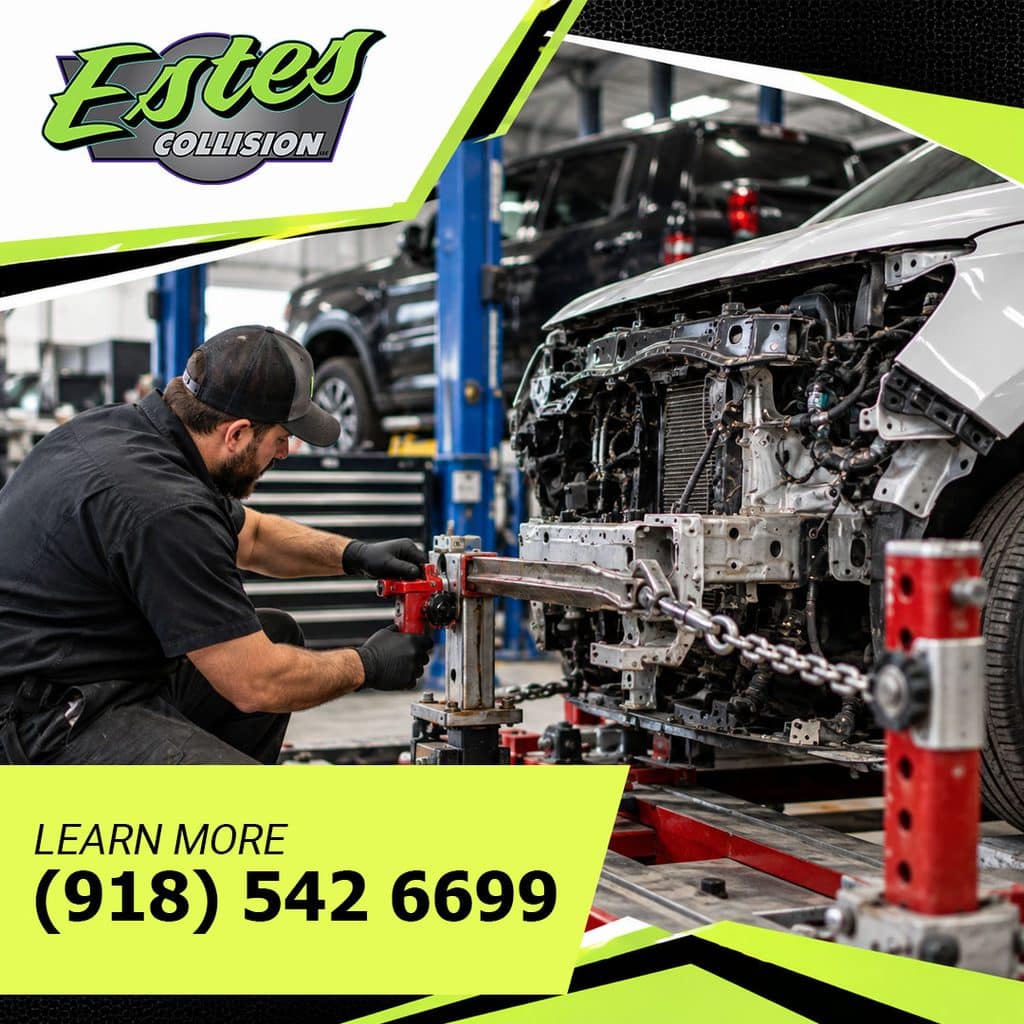 Technician using a frame machine with chains and clamps to repair a collision-damaged car in an auto body shop